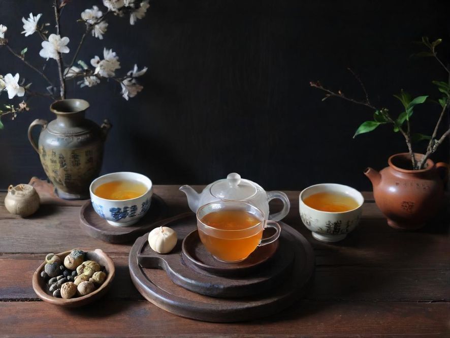 一只手轻柔地端着精致的茶具,暖色调的光影勾勒出私密而温馨的氛围,细节尽显品味。